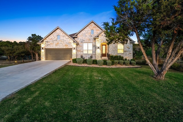 view of front of property featuring a garage and a yard