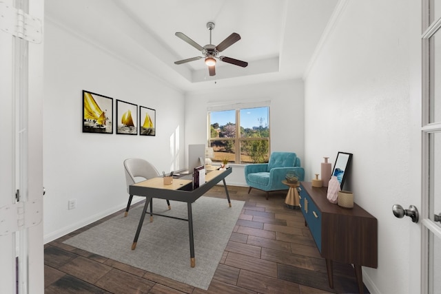 office area featuring ceiling fan, dark hardwood / wood-style floors, and a tray ceiling