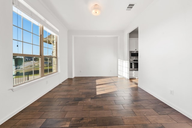 unfurnished room with crown molding and dark hardwood / wood-style flooring