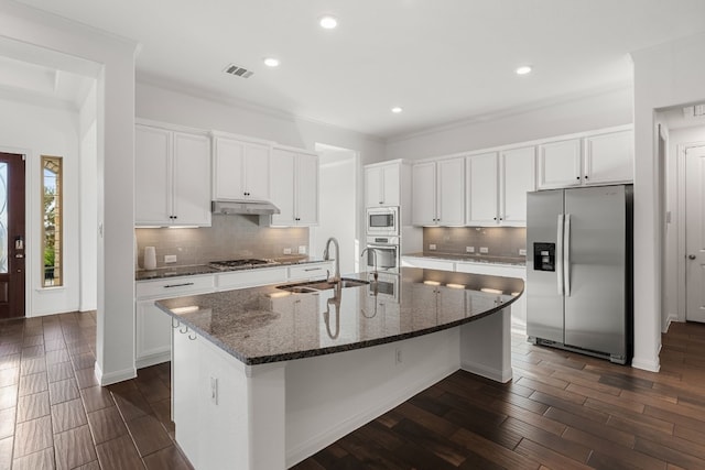 kitchen featuring a center island with sink, white cabinetry, appliances with stainless steel finishes, dark hardwood / wood-style floors, and sink