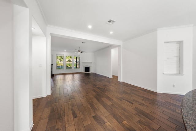 unfurnished living room featuring ceiling fan, dark hardwood / wood-style floors, and crown molding