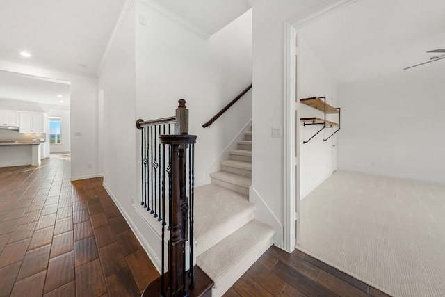 stairs featuring hardwood / wood-style floors and ornamental molding