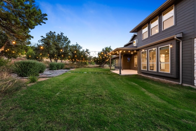 yard at dusk with a patio