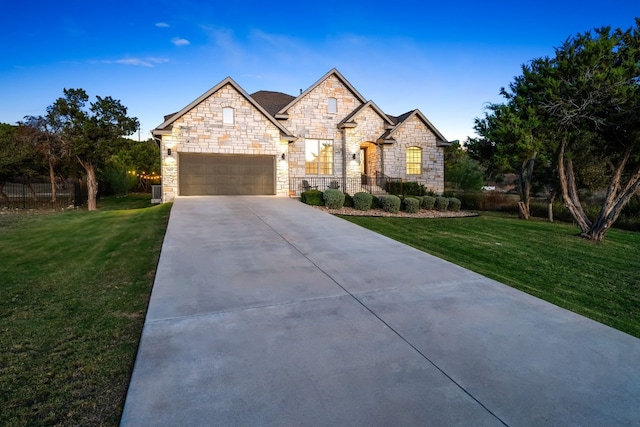 view of front of house with a garage and a front lawn