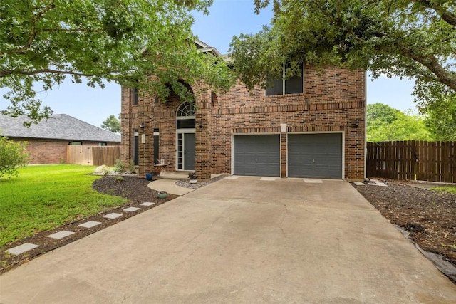 900 Laurel Cv, Buda, TX 78610 - view of front facade with a garage, brick siding, and concrete driveway