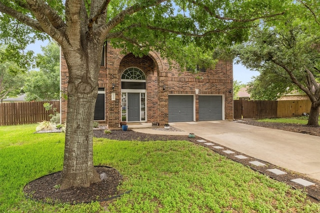 view of property with a garage and a front yard