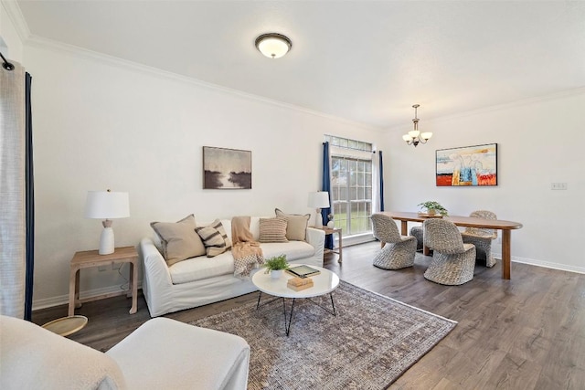 900 Laurel Cv, Buda, TX 78610 - living room with a chandelier, ornamental molding, wood finished floors, and baseboards
