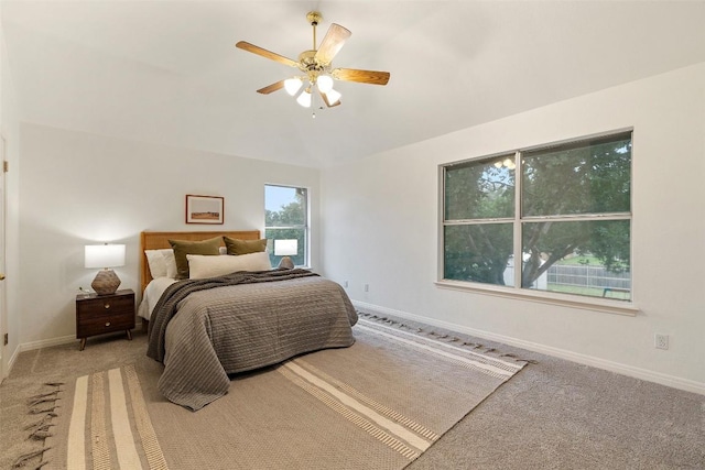 900 Laurel Cv, Buda, TX 78610 - bedroom featuring light carpet, baseboards, ceiling fan, and vaulted ceiling