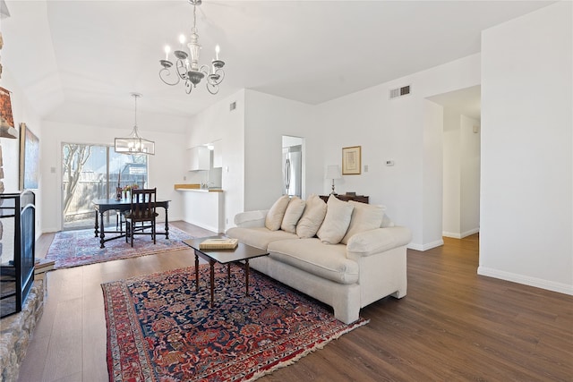 living room with dark hardwood / wood-style flooring and a notable chandelier