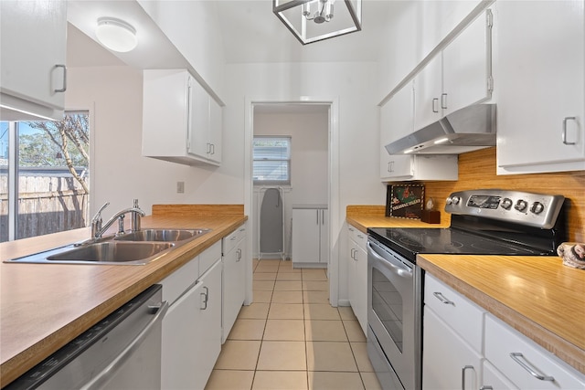 kitchen with white cabinetry, a wealth of natural light, sink, and stainless steel appliances