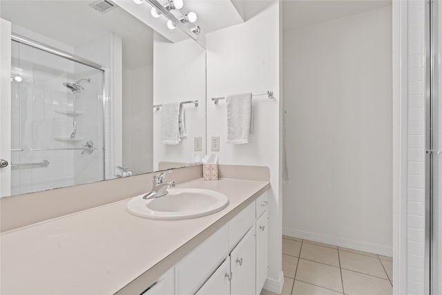 bathroom with vanity, tile patterned floors, and a shower with door