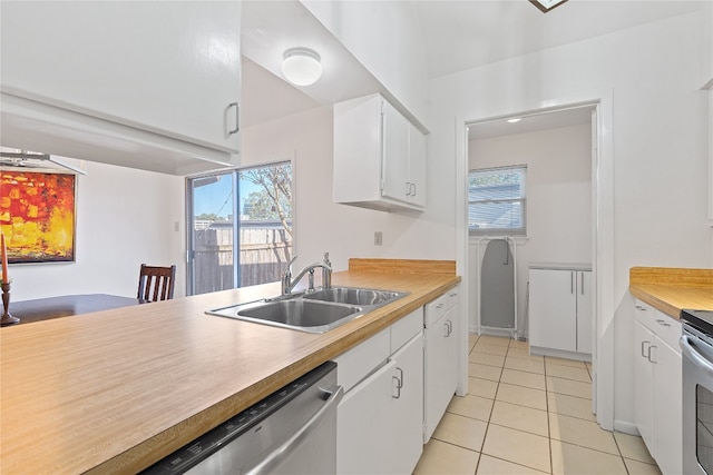 kitchen with white cabinetry, stainless steel appliances, sink, and light tile patterned flooring