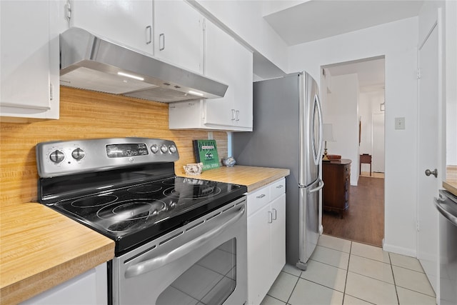 kitchen featuring white cabinets, light tile patterned floors, appliances with stainless steel finishes, and tasteful backsplash