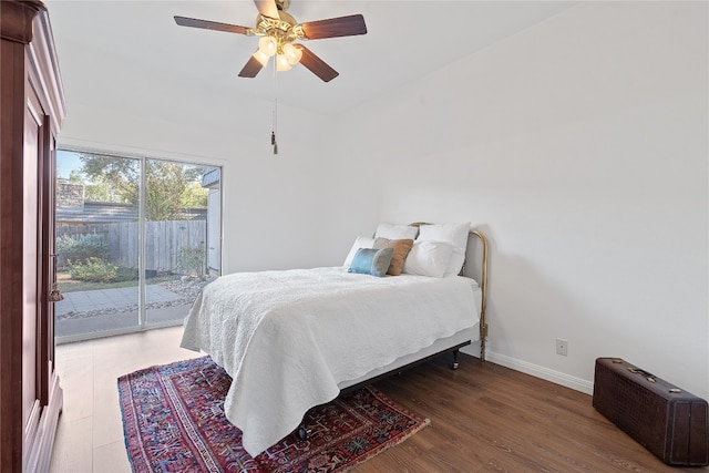 bedroom with access to exterior, hardwood / wood-style floors, and ceiling fan