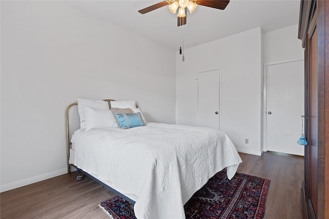 bedroom featuring dark hardwood / wood-style floors and ceiling fan