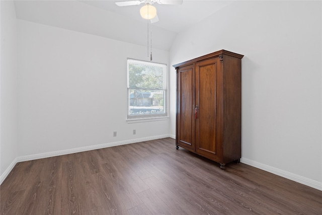 unfurnished bedroom with dark hardwood / wood-style flooring, lofted ceiling, and ceiling fan