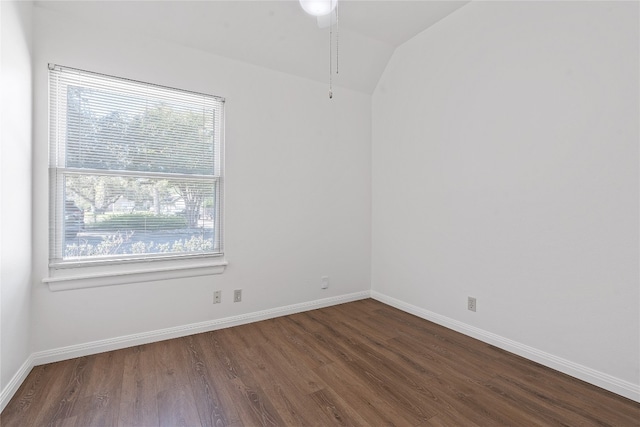 empty room featuring dark wood-type flooring, plenty of natural light, and lofted ceiling