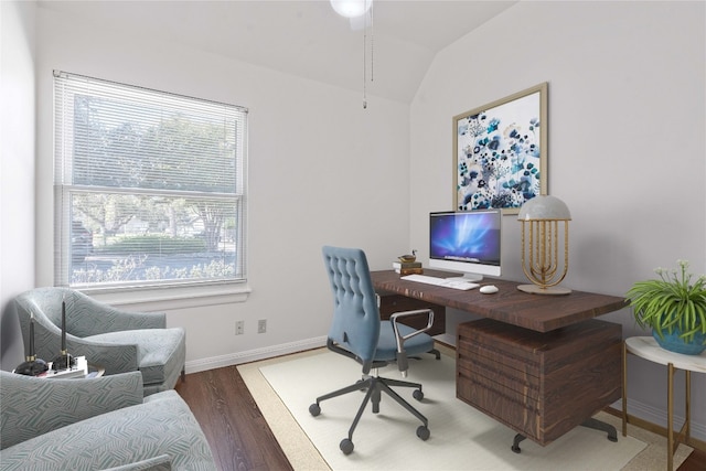 home office with vaulted ceiling and dark hardwood / wood-style flooring