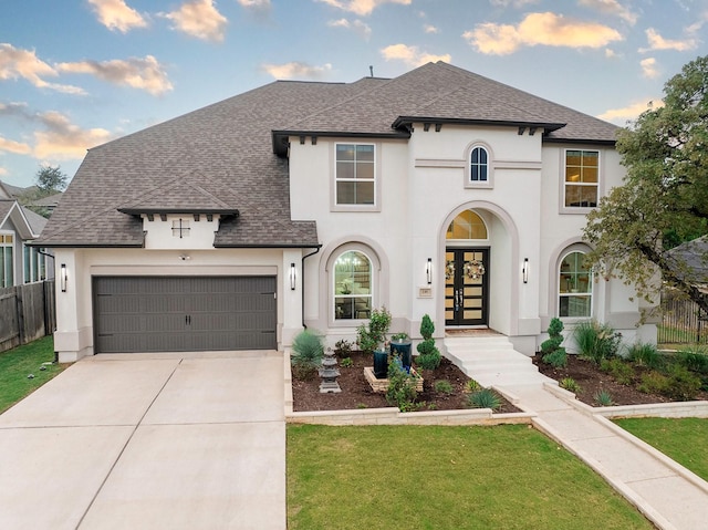 view of front facade with a garage and a front lawn