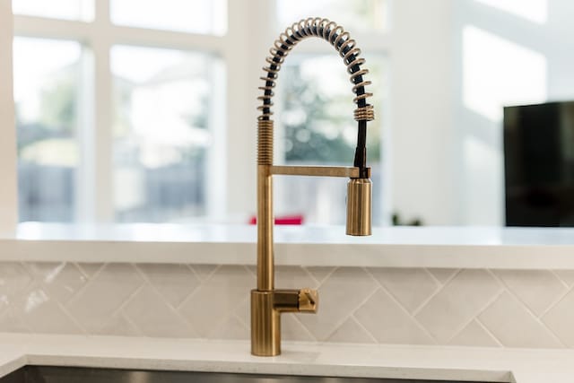 interior details featuring tasteful backsplash and sink