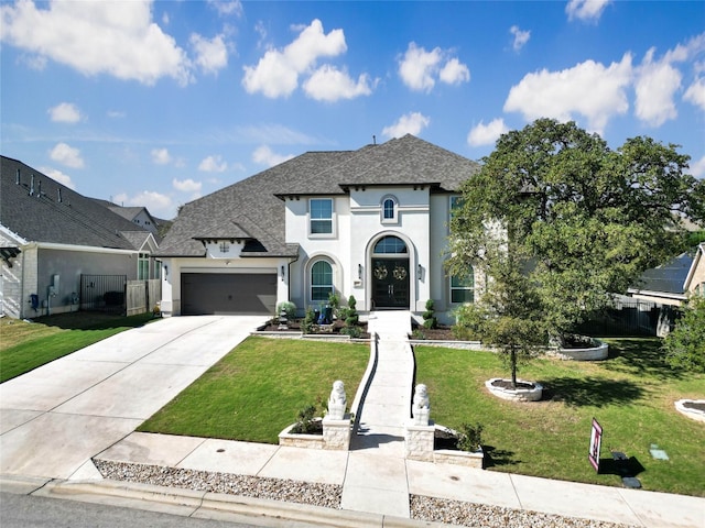 french country inspired facade featuring a garage and a front lawn