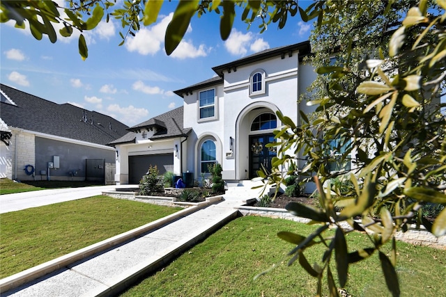 view of front facade with a garage and a front lawn