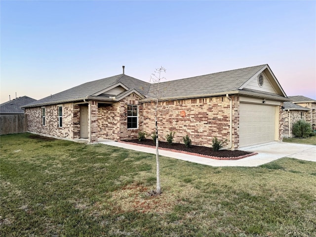 single story home with a yard and a garage