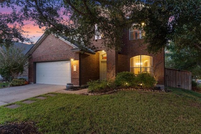 view of front property with a lawn and a garage