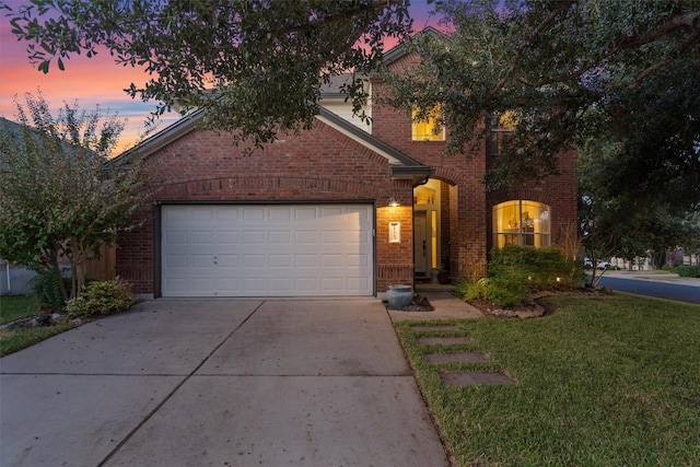 view of front of house featuring a garage and a lawn