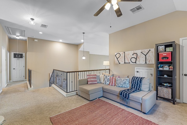 carpeted living room featuring ceiling fan and vaulted ceiling