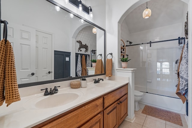 full bathroom featuring shower / bath combination with glass door, vanity, tile patterned floors, and toilet