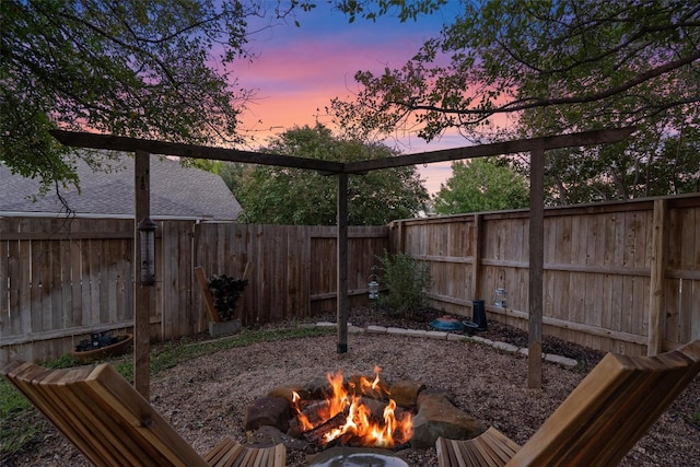 yard at dusk with an outdoor fire pit