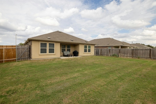 rear view of property featuring a patio area and a yard