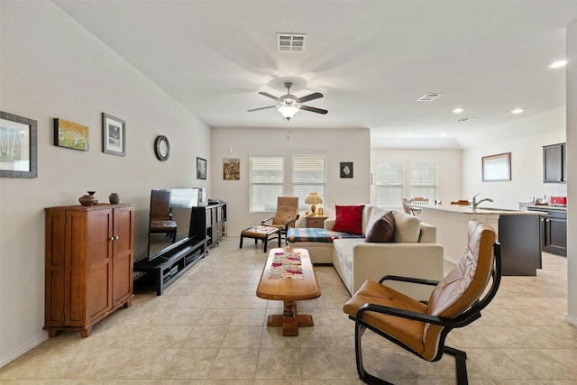 tiled living room featuring ceiling fan