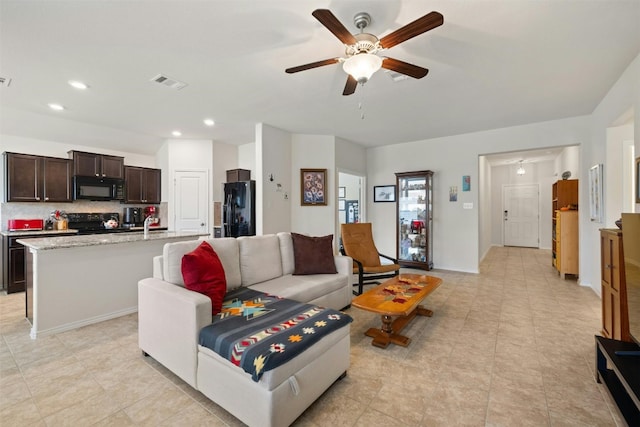 tiled living room featuring ceiling fan