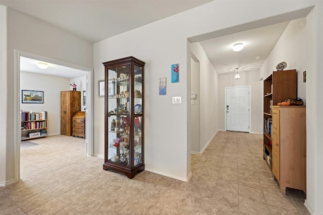 hall featuring light tile patterned floors