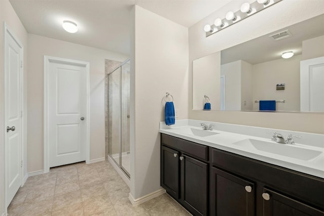 bathroom with vanity, tile patterned floors, and a shower with shower door