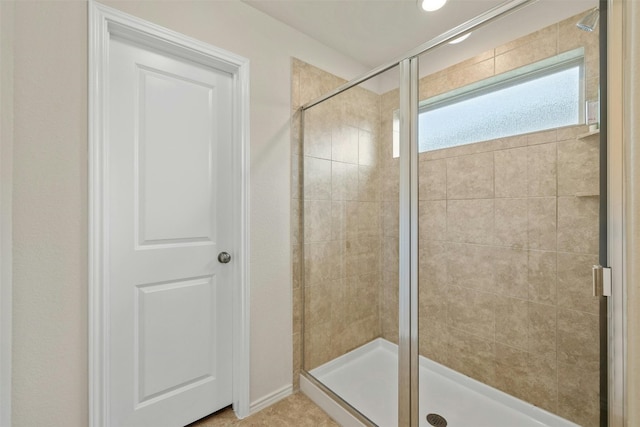 bathroom featuring a shower with door