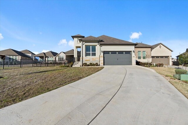 view of front of home featuring a front yard and a garage