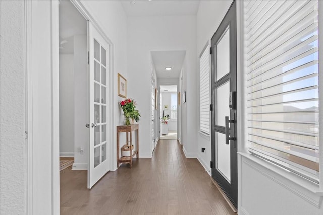 hallway featuring french doors and dark hardwood / wood-style floors