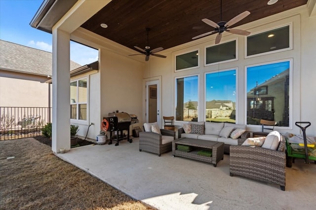 view of patio with grilling area, an outdoor living space, and ceiling fan