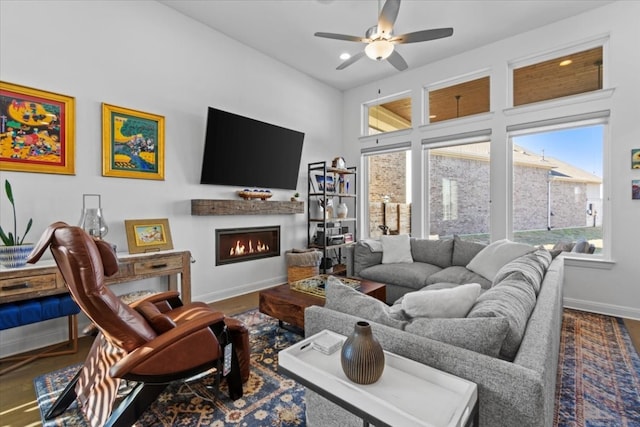 living room featuring ceiling fan and hardwood / wood-style flooring