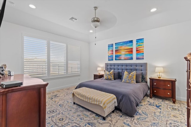 bedroom with ceiling fan and multiple windows