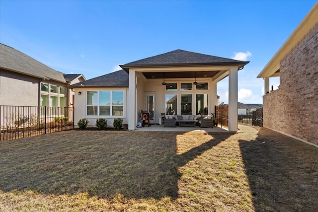 rear view of house featuring ceiling fan, a patio area, outdoor lounge area, and a yard