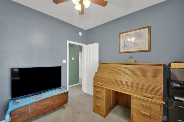 carpeted home office featuring ceiling fan