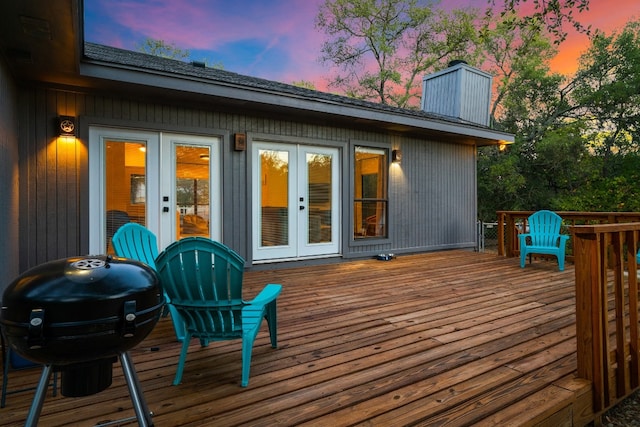 deck at dusk featuring grilling area and french doors