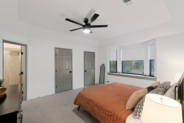 bedroom with carpet, ceiling fan, and a tray ceiling