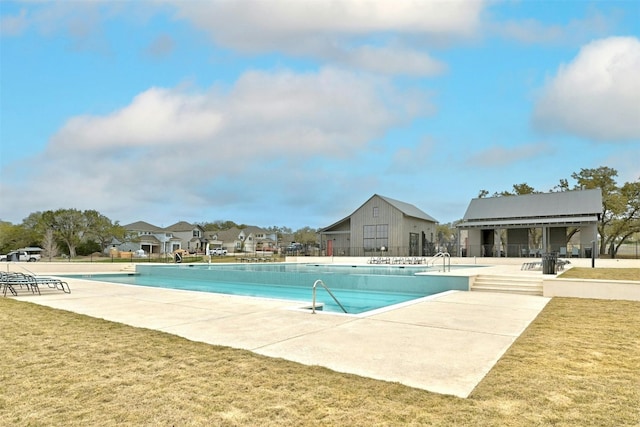 view of swimming pool featuring a lawn and a patio area