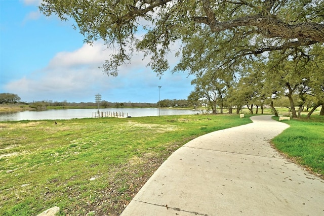 view of property's community featuring a water view and a lawn