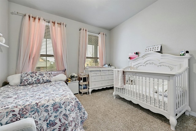 bedroom featuring carpet floors and vaulted ceiling